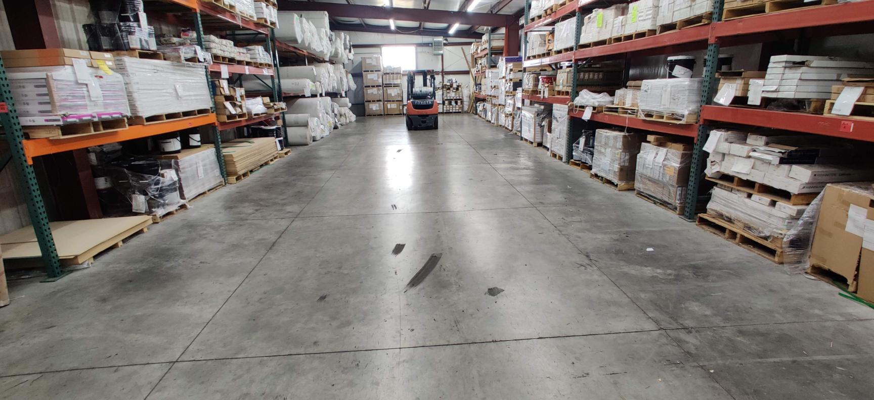 Stocked flooring on warehouse racks at Showcase Interiors