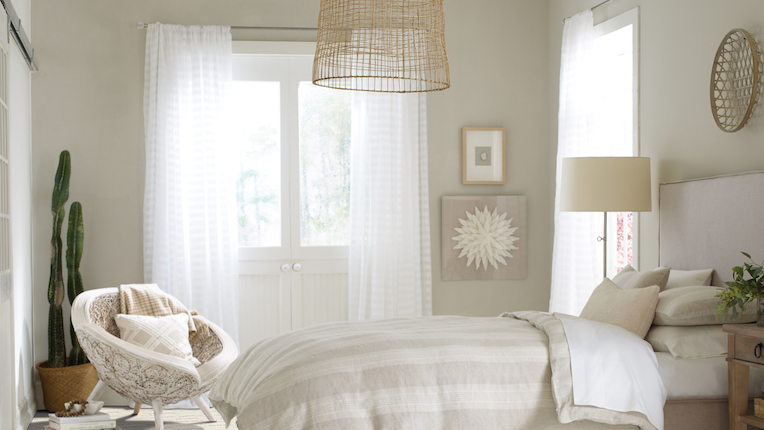 breezy white curtains in a bright bedroom